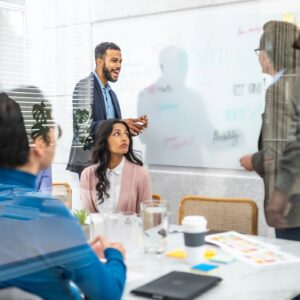 Corporate employees using kanban project planning technique in conference room